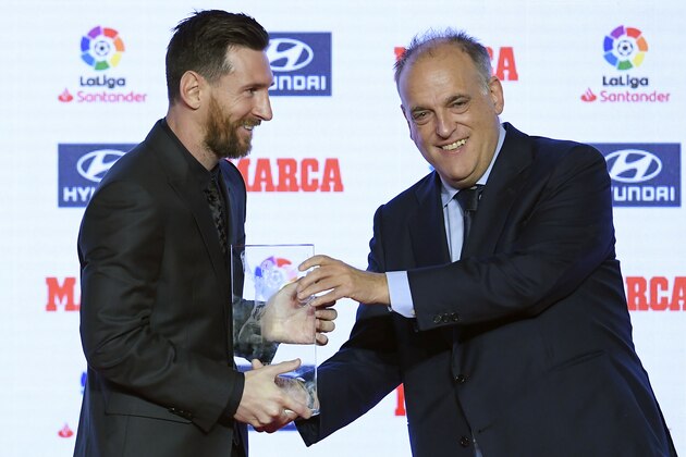 Barcelona's Argentinian forward Lionel Messi (L) receives the Alfredo Di Stefano trophy from president of La Liga, Javier Tebas, for the 2017-18 best player of the Spanish Liga, during the presentation of the Football Marca Awards in Barcelona on November 12, 2018. (Photo by LLUIS GENE / AFP)        (Photo credit should read LLUIS GENE/AFP/Getty Images)