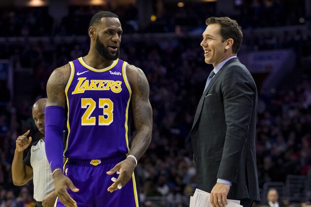 Los Angeles Lakers' head coach Luke Walton, right, talks things over with LeBron James, left, during the first half of an NBA basketball game against the Philadelphia 76ers, Sunday, Feb. 10, 2019, in Philadelphia. The 76ers won 143-120. (AP Photo/Chris Szagola)