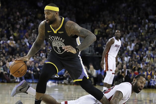 Golden State Warriors' DeMarcus Cousins (0) drives past Miami Heat forward James Johnson during the second half of an NBA basketball game, Sunday, Feb. 10, 2019, in Oakland, Calif. (AP Photo/Ben Margot)