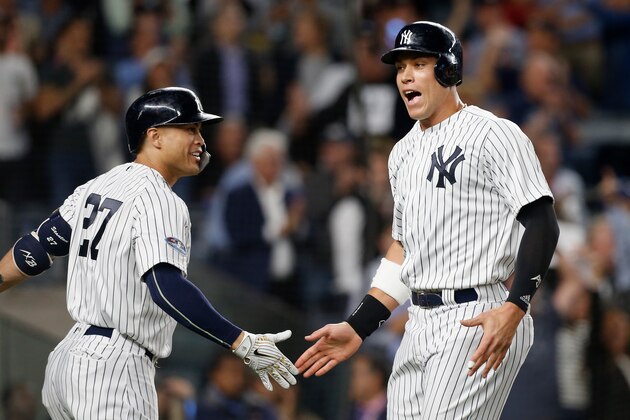NEW YORK, NY - OCTOBER 03:  (NEW YORK DAILIES OUT)   Aaron Judge #99 and Giancarlo Stanton #27 of the New York Yankees during the sixth inning against the Oakland Athletics in the American League Wild Card Game at Yankee Stadium on October 3, 2018 in the Bronx borough of New York City. The Yankees defeated the Athletics 7-2.  (Photo by Jim McIsaac/Getty Images)