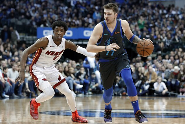 Miami Heat's Josh Richardson (0) defends as Dallas Mavericks' Luka Doncic (77) advances the ball up court during an NBA basketball game in Dallas, Wednesday, Feb. 13, 2019. (AP Photo/Tony Gutierrez)