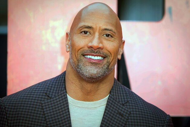 FILE - In this April 11, 2018, file photo, actor Dwayne Johnson poses for photographers at the premiere of the