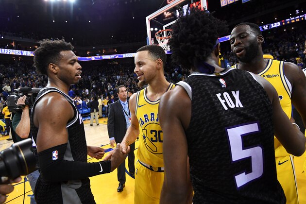 OAKLAND, CA - FEBRUARY 21:  Buddy Hield #24 of the Sacramento Kings greets Stephen Curry #30 of the Golden State Warriors after the game on February 21, 2019 at ORACLE Arena in Oakland, California. NOTE TO USER: User expressly acknowledges and agrees that, by downloading and or using this photograph, user is consenting to the terms and conditions of Getty Images License Agreement. Mandatory Copyright Notice: Copyright 2019 NBAE (Photo by Noah Graham/NBAE via Getty Images)