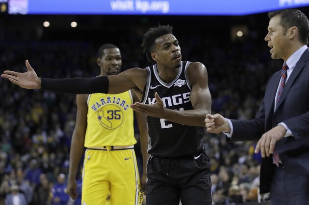 Sacramento Kings' Buddy Hield, center, gestures to coach Dave Joerger, right, during the second half of the team's NBA basketball game against the Golden State Warriors on Thursday, Feb. 21, 2019, in Oakland, Calif. (AP Photo/Ben Margot)