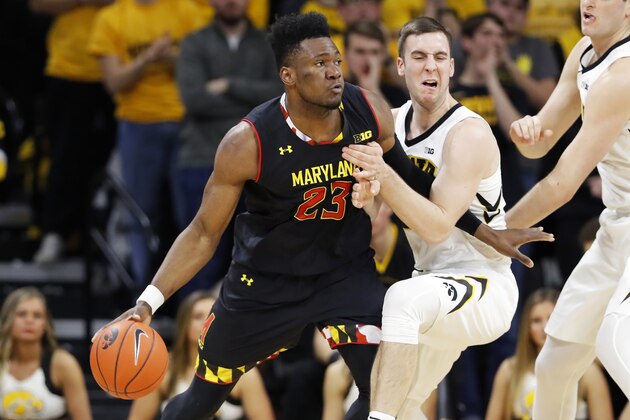 Maryland forward Bruno Fernando (23) drives past Iowa guard Connor McCaffery during the second half of an NCAA college basketball game Tuesday, Feb. 19, 2019, in Iowa City, Iowa. Maryland won 66-65. (AP Photo/Charlie Neibergall)