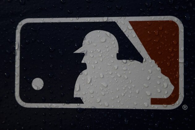 A rain-covered logo is seen at Fenway Park before Game 1 of the World Series baseball game between the Boston Red Sox and the Los Angeles Dodgers Tuesday, Oct. 23, 2018, in Boston. (AP Photo/Matt Slocum)