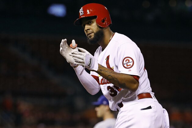 St. Louis Cardinals' Jose Martinez gestures toward his dugout after hitting a single during the ninth inning of a baseball game against the Los Angeles Dodgers Thursday, Sept. 13, 2018, in St. Louis. (AP Photo/Billy Hurst)