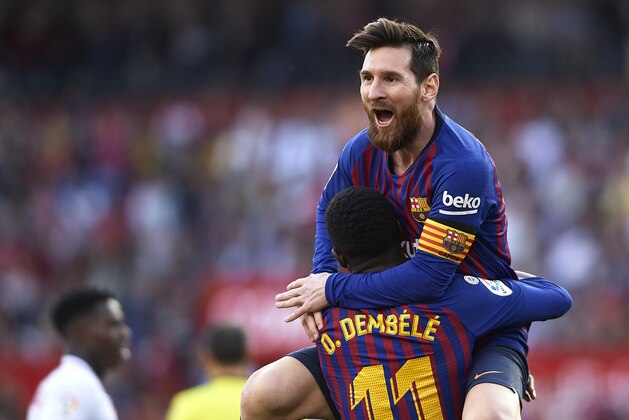 SEVILLE, SPAIN - FEBRUARY 23: Lionel Messi of Barcelona celebrates after scoring his team's second goal with his teammate Ousmane Dembele during the La Liga match between Sevilla FC and FC Barcelona at Estadio Ramon Sanchez Pizjuan on February 23, 2019 in Seville, Spain. (Photo by Quality Sport Images/Getty Images)