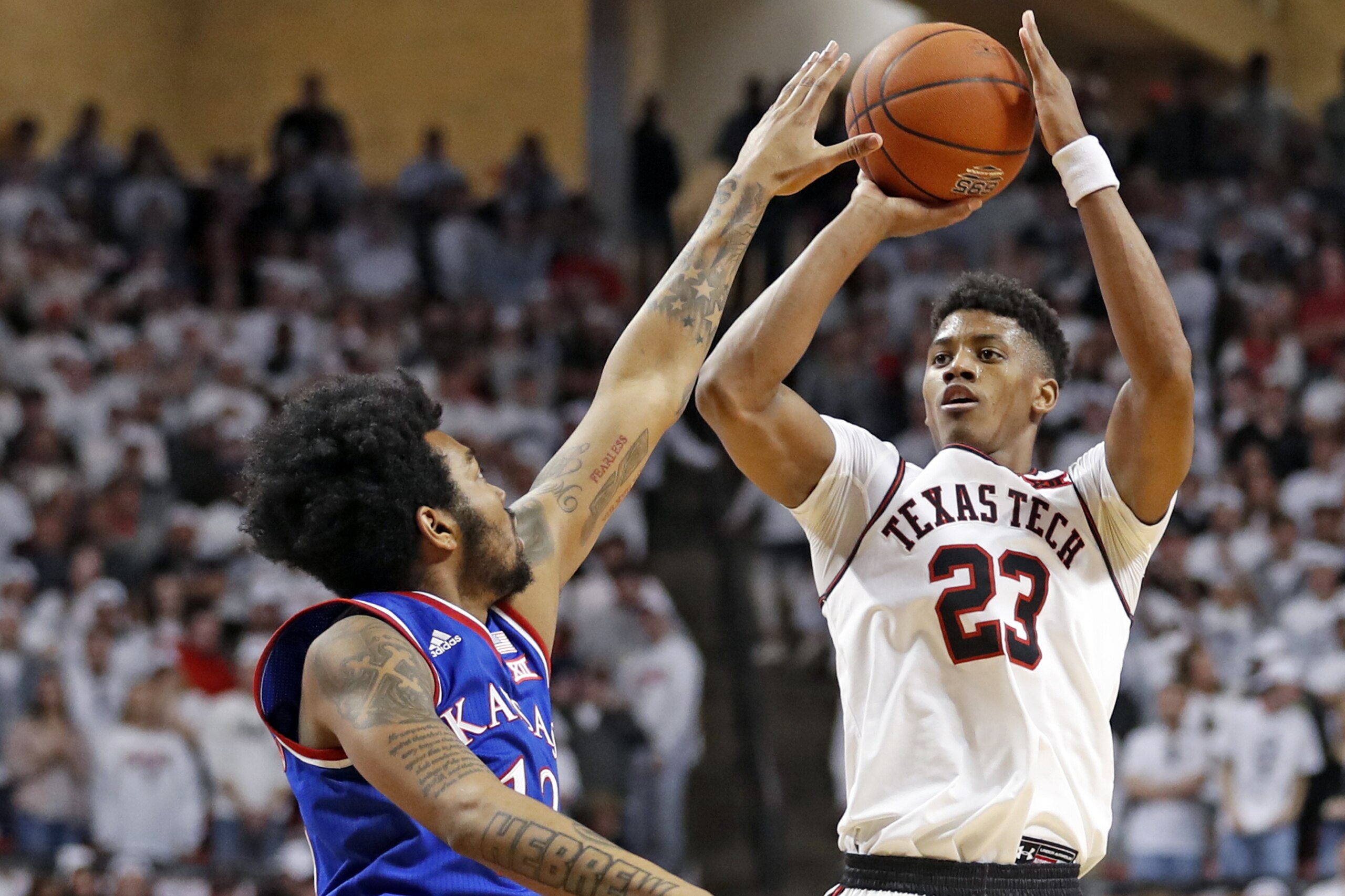 Texas Tech's Jarrett Culver (23) shoots over Kansas' K.J. Lawson (13) during the second half of an NCAA college basketball game Saturday, Feb. 23, 2019, in Lubbock, Texas. (AP Photo/Brad Tollefson)