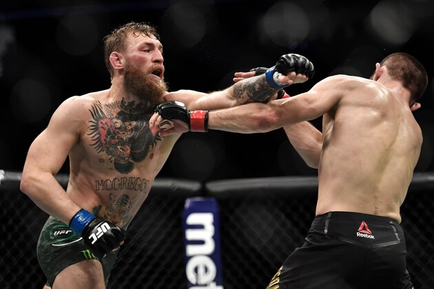 LAS VEGAS, NV - OCTOBER 06:  (L-R) Conor McGregor of Ireland punches Khabib Nurmagomedov of Russia in their UFC lightweight championship bout during the UFC 229 event inside T-Mobile Arena on October 6, 2018 in Las Vegas, Nevada. (Photo by Brandon Magnus/Zuffa LLC/Zuffa LLC via Getty Images)