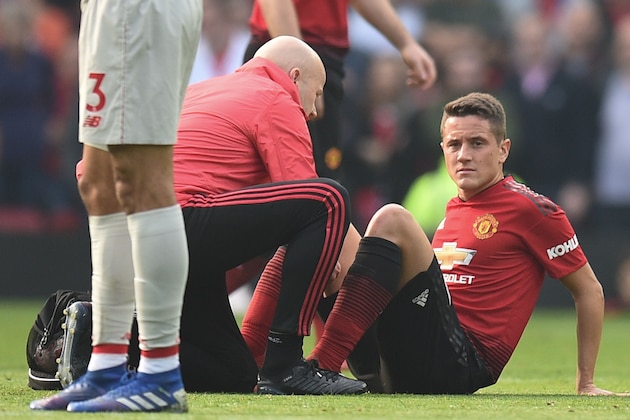 Manchester United's Spanish midfielder Ander Herrera (R) gets attention on the field before going off injured during the English Premier League football match between Manchester United and Liverpool at Old Trafford in Manchester, north west England, on February 24, 2019. (Photo by Oli SCARFF / AFP) / RESTRICTED TO EDITORIAL USE. No use with unauthorized audio, video, data, fixture lists, club/league logos or 'live' services. Online in-match use limited to 120 images. An additional 40 images may be used in extra time. No video emulation. Social media in-match use limited to 120 images. An additional 40 images may be used in extra time. No use in betting publications, games or single club/league/player publications. /         (Photo credit should read OLI SCARFF/AFP/Getty Images)