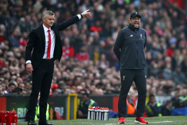 MANCHESTER, ENGLAND - FEBRUARY 24:  Jurgen Klopp, Manager of Liverpool and Ole Gunnar Solskjaer, Interim Manager of Manchester United react during the Premier League match between Manchester United and Liverpool FC at Old Trafford on February 24, 2019 in Manchester, United Kingdom.  (Photo by Clive Brunskill/Getty Images)