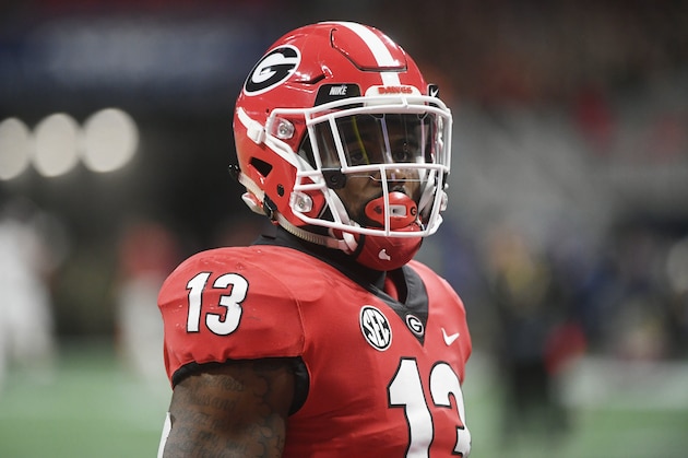 Georgia running back Elijah Holyfield (13) warms up before the first half of the Southeastern Conference championship NCAA college football game between Georgia and Alabama, Saturday, Dec. 1, 2018, in Atlanta. (AP Photo/John Amis)