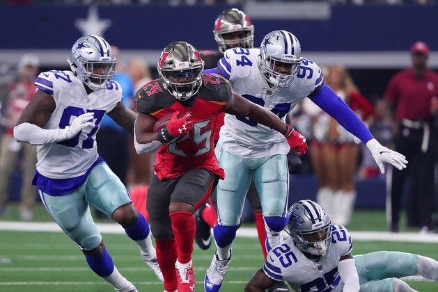 ARLINGTON, TEXAS - DECEMBER 23: Peyton Barber #25 of the Tampa Bay Buccaneers breaks away from Taco Charlton #97, Randy Gregory #94, and #25 of the Dallas Cowboys in the third quarter at AT&T Stadium on December 23, 2018 in Arlington, Texas. (Photo by Tom Pennington/Getty Images) ARLINGTON, TEXAS - DECEMBER 23: Peyton Barber #25 of the Tampa Bay Buccaneers breaks away from Taco Charlton #97, Randy Gregory #94, and #25 of the Dallas Cowboys in the third quarter at AT&T Stadium on December 23, 2018 in Arlington, Texas. (Photo by Tom Pennington/Getty Images)