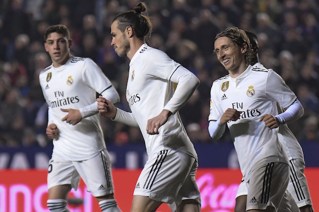 Real Madrid's Welsh forward Gareth Bale (C) celebrates with teammates after scoring a goal during the Spanish league football match between Levante UD and Real Madrid CF at the Ciutat de Valencia stadium in Valencia on February 24, 2019. (Photo by JOSE JORDAN / AFP)        (Photo credit should read JOSE JORDAN/AFP/Getty Images)