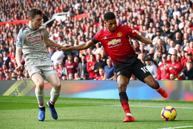 MANCHESTER, ENGLAND - FEBRUARY 24:  Marcus Rashford of Manchester United battles for possession with Andy Robertson of Liverpool during the Premier League match between Manchester United and Liverpool FC at Old Trafford on February 24, 2019 in Manchester, United Kingdom.  (Photo by Clive Brunskill/Getty Images)