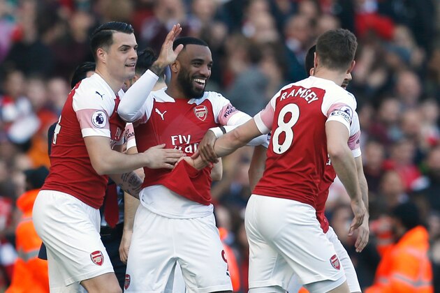 Arsenal's French striker Alexandre Lacazette celebrates with teammates after scoring during the English Premier League football match between Arsenal and Southampton at the Emirates Stadium in London on February 24, 2019. (Photo by Ian KINGTON / AFP) / RESTRICTED TO EDITORIAL USE. No use with unauthorized audio, video, data, fixture lists, club/league logos or 'live' services. Online in-match use limited to 120 images. An additional 40 images may be used in extra time. No video emulation. Social media in-match use limited to 120 images. An additional 40 images may be used in extra time. No use in betting publications, games or single club/league/player publications. /         (Photo credit should read IAN KINGTON/AFP/Getty Images)
