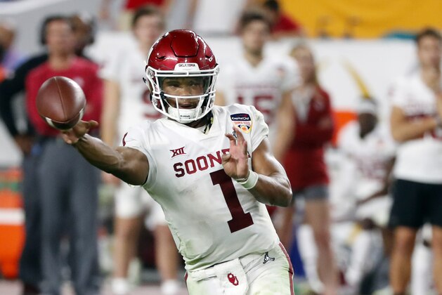 FILE - In this Dec. 29, 2018, file photo, Oklahoma quarterback Kyler Murray throws a pass during the second half of the Orange Bowl NCAA college football game against Alabama in Miami Gardens, Fla. The Oakland Athletics remain hopeful of seeing Heisman Trophy winner Murray in their baseball uniform when spring training begins next month. While the Oklahoma quarterback declared for the NFL draft last week, the prized outfielder could report to A’s spring training in Mesa, Arizona--and he has an invite to big league camp. (AP Photo/Wilfredo Lee, File)