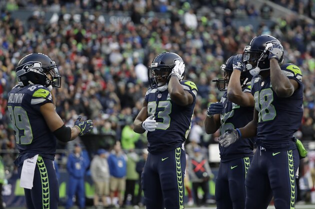 Seattle Seahawks wide receiver Jaron Brown, right, takes part in a dancing touchdown celebration with teammates after he caught a pass for a touchdown against the San Francisco 49ers during the second half of an NFL football game, Sunday, Dec. 2, 2018, in Seattle. (AP Photo/Elaine Thompson)
