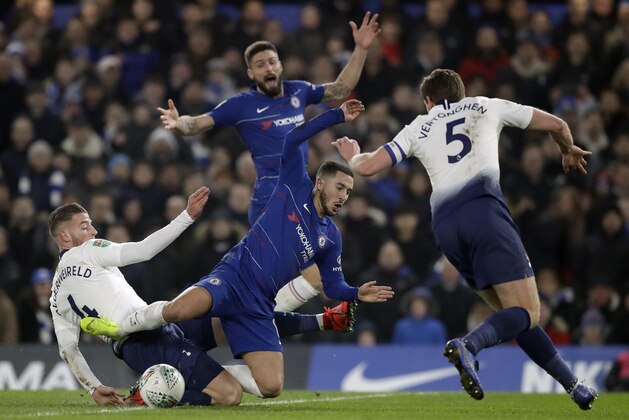 Chelsea's Eden Hazard, center, duels for the ball with Tottenham Hotspur's Toby Alderweireld during the second leg of the English League Cup semifinal soccer match between Chelsea and Tottenham Hotspur at Stamford Bridge stadium in London, Thursday, Jan. 24, 2019. (AP Photo/Matt Dunham)