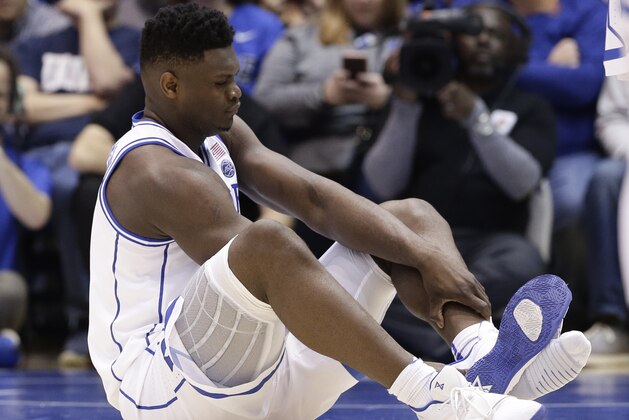 Duke's Zion Williamson sits on the floor following an injury during the first half of an NCAA college basketball game against North Carolina in Durham, N.C., Wednesday, Feb. 20, 2019. (AP Photo/Gerry Broome)