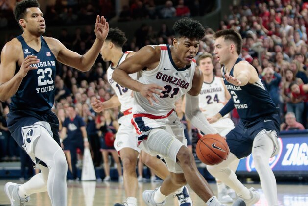 SPOKANE, WA - FEBRUARY 23:  Rui Hachimura #21 of the Gonzaga Bulldogs drives against Yoeli Childs #23 and Zac Seljaas #2 of the BYU Cougars in the second half at McCarthey Athletic Center on February 23, 2019 in Spokane, Washington.  Gonzaga defeated BYU 102-68.  (Photo by William Mancebo/Getty Images)
