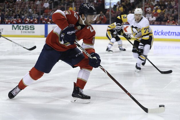 Florida Panthers center Derick Brassard (25) skates with the puck as Pittsburgh Penguins defenseman Jack Johnson (73) defends during the second period of an NHL hockey game, Thursday, Feb. 7, 2019, in Sunrise, Fla. (AP Photo/Lynne Sladky)