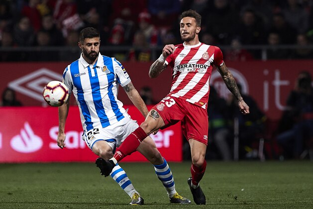 GIRONA, SPAIN - FEBRUARY 25: Aleix Garcia of Girona FC competes for the ball with Raul Navas of Real Sociedad during the La Liga match between Girona FC and Real Sociedad at Montilivi Stadium on February 25, 2019 in Girona, Spain. (Photo by Quality Sport Images/Getty Images)