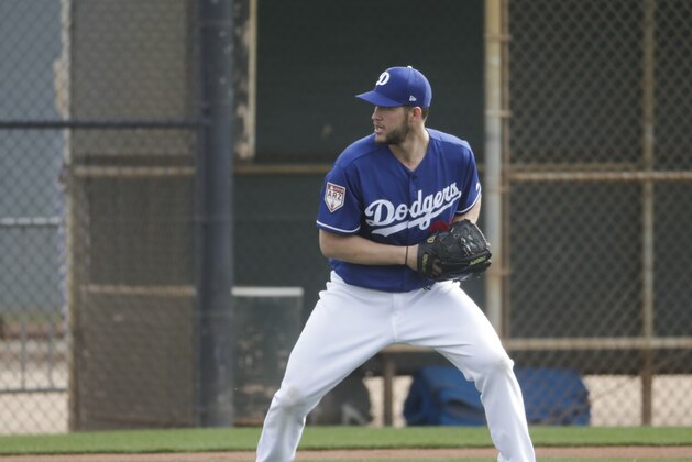 Los Angeles Dodgers' Clayton Kershaw makes a play during a spring training baseball workout Wednesday, Feb. 13, 2019, in Glendale, Ariz. (AP Photo/Morry Gash)