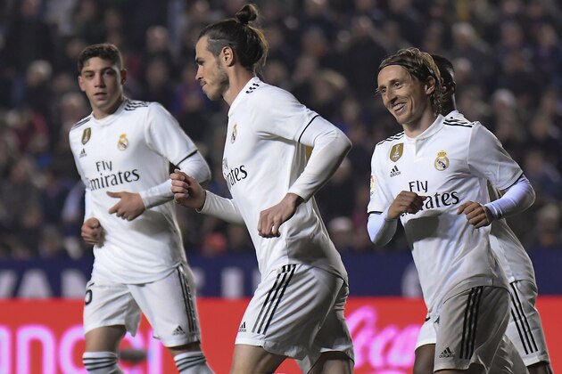 Real Madrid's Welsh forward Gareth Bale (C) celebrates with teammates after scoring a goal during the Spanish league football match between Levante UD and Real Madrid CF at the Ciutat de Valencia stadium in Valencia on February 24, 2019. (Photo by JOSE JORDAN / AFP)        (Photo credit should read JOSE JORDAN/AFP/Getty Images)