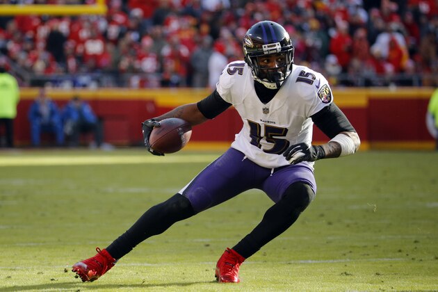 Baltimore Ravens wide receiver Michael Crabtree (15) carries the ball during the second half of an NFL football game against the Kansas City Chiefs in Kansas City, Mo., Sunday, Dec. 9, 2018. (AP Photo/Charlie Riedel)