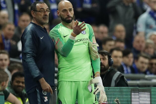 Chelsea's manager Maurizio Sarri, left, talks to Chelsea's goalkeeper Willy Caballero, right, during the English League Cup final soccer match between Chelsea and Manchester City at Wembley stadium in London, England, Sunday, Feb. 24, 2019. (AP Photo/Alastair Grant)