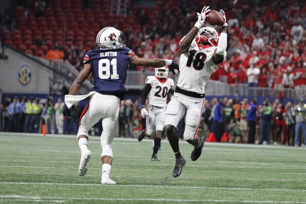 Georgia defensive back Deandre Baker (18) makes an interception against Auburn wide receiver Darius Slayton (81) during the first half of the Southeastern Conference championship NCAA college football game, Saturday, Dec. 2, 2017, in Atlanta. The play was ruled a penalty and no interception was made.(AP Photo/David Goldman)