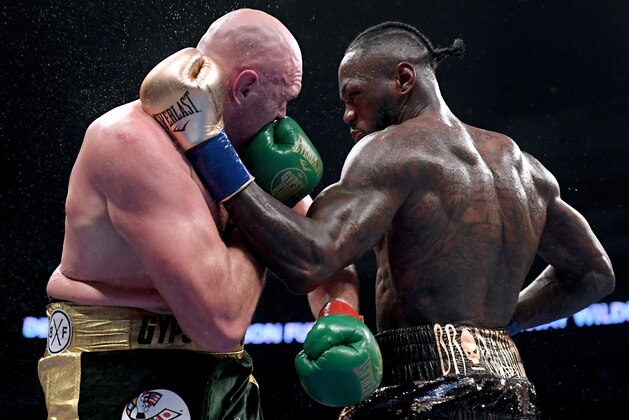 LOS ANGELES, CA - DECEMBER 01:  Deontay Wilder and Tyson Fury punch each other in the ninth round fighting to a draw during the WBC Heavyweight Championship at Staples Center on December 1, 2018 in Los Angeles, California.  (Photo by Harry How/Getty Images)