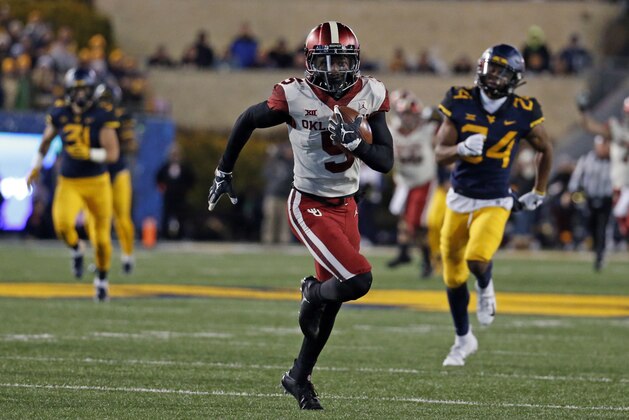 MORGANTOWN, WV - NOVEMBER 23:  Marquise Brown #5 of the Oklahoma Sooners runs after catching a 65 yard pass against the West Virginia Mountaineers on November 23, 2018 at Mountaineer Field in Morgantown, West Virginia.  (Photo by Justin K. Aller/Getty Images)