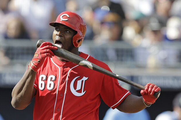Cincinnati Reds' Yasiel Puig licks his bat during the third inning of a spring training baseball game against the Seattle Mariners, Monday, Feb. 25, 2019, in Peoria, Ariz. (AP Photo/Darron Cummings)