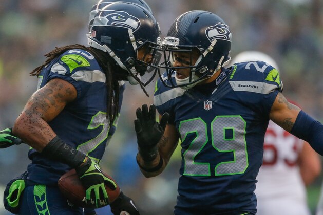 SEATTLE, WA - DECEMBER 22:  Cornerback Richard Sherman #25 of the Seattle Seahawks celebrates with free safety Earl Thomas #29 after making an interception against the Arizona Cardinals at CenturyLink Field on December 22, 2013 in Seattle, Washington.  (Photo by Otto Greule Jr/Getty Images)