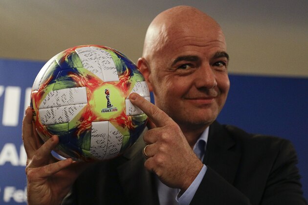 FIFA President Gianni Infantino holds the official ball of the upcoming Women's Soccer World Championship as he poses for photographers during a press conference at the end of an executive committee meeting in Rome, Wednesday, Feb. 27, 2019. (AP Photo/Gregorio Borgia)