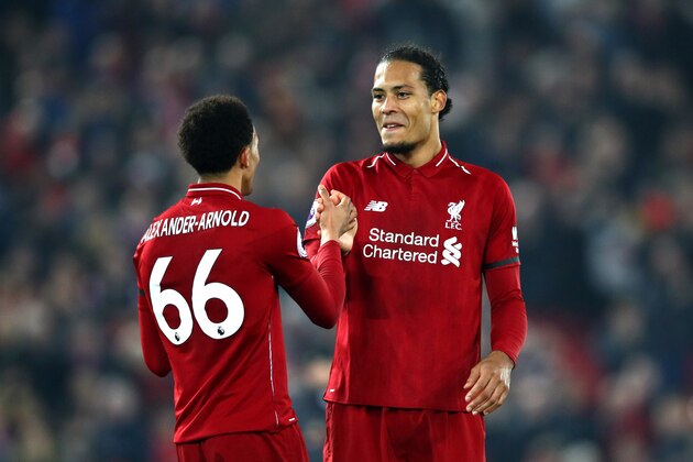 LIVERPOOL, ENGLAND - FEBRUARY 27: Virgil van Dijk of Liverpool and Trent Alexander-Arnold of Liverpool shake hands during the Premier League match between Liverpool FC and Watford FC at Anfield on February 27, 2019 in Liverpool, United Kingdom. (Photo by Clive Brunskill/Getty Images)