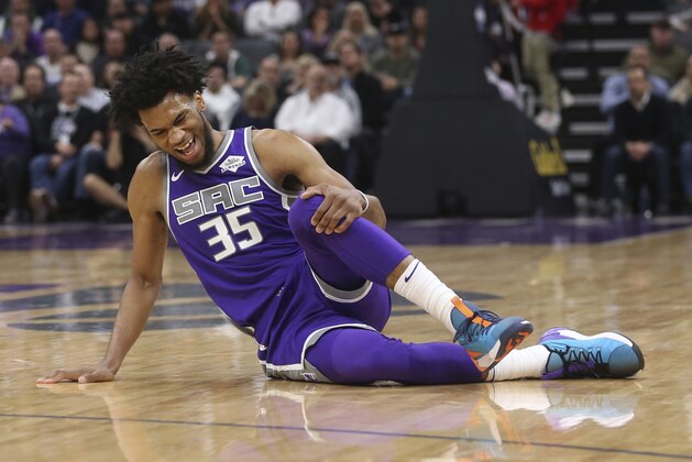 Sacramento Kings forward Marvin Bagley III reacts as he got injured his knee during the second half of an NBA basketball game against the Milwaukee Bucks in Sacramento, Calif., Wednesday, Feb. 27, 2019. The Bucks won, in overtime,141-140.(AP Photo/Rich Pedroncelli)