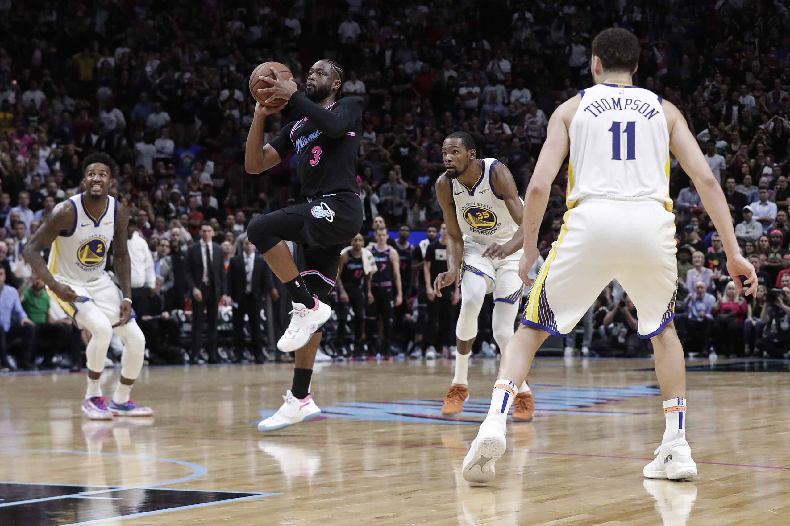 Miami Heat guard Dwyane Wade (3) starts to shoot a 3-pointer at the buzzer against the Golden State Warriors in an NBA basketball Wednesday, Feb. 27, 2019, in Miami. The Heat won 126-125. (AP Photo/Brynn Anderson)