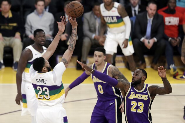 New Orleans Pelicans' Anthony Davis, left, shoots over Los Angeles Lakers' LeBron James (23) during the first half of an NBA basketball game Wednesday, Feb. 27, 2019, in Los Angeles. (AP Photo/Marcio Jose Sanchez)