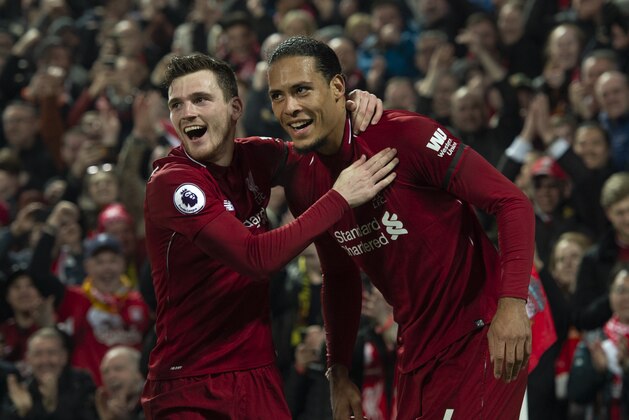 LIVERPOOL, ENGLAND - FEBRUARY 27: Virgil van Dijk of Liverpool celebrates scoring his second goal with team mate Andrew Robertson during the Premier League match between Liverpool FC and Watford FC at Anfield on February 27, 2019 in Liverpool, United Kingdom. (Photo by Visionhaus/Getty Images)