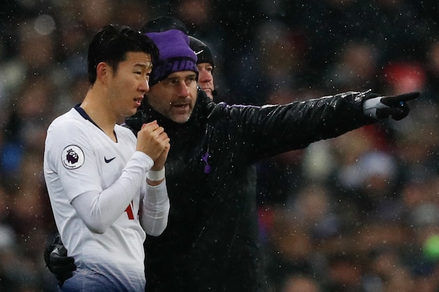 Tottenham Hotspur's Argentinian head coach Mauricio Pochettino (R) gives instructions to substitute Tottenham Hotspur's South Korean striker Son Heung-Min (L) during the English Premier League football match between Tottenham Hotspur and Burnley at Wembley Stadium in London on December 15, 2018. (Photo by Adrian DENNIS / AFP) / RESTRICTED TO EDITORIAL USE. No use with unauthorized audio, video, data, fixture lists, club/league logos or 'live' services. Online in-match use limited to 120 images. An additional 40 images may be used in extra time. No video emulation. Social media in-match use limited to 120 images. An additional 40 images may be used in extra time. No use in betting publications, games or single club/league/player publications. /         (Photo credit should read ADRIAN DENNIS/AFP/Getty Images)