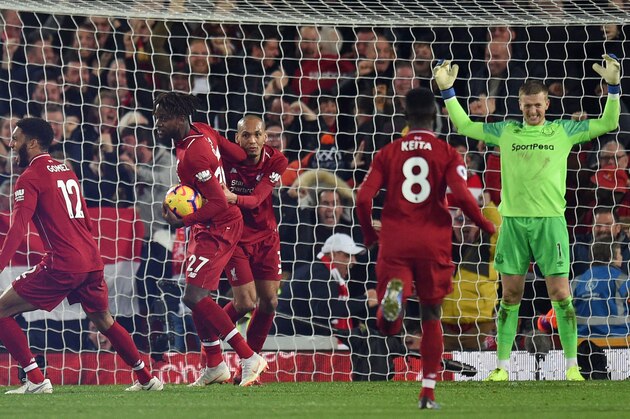 Everton's English goalkeeper Jordan Pickford (R) reacts after his late mistake allows Liverpool's Belgian striker Divock Origi (2nd L) to score the winner during the English Premier League football match between Liverpool and Everton at Anfield in Liverpool, north west England on December 2, 2018. - Liverpool won the game 1-0. (Photo by Oli SCARFF / AFP) / RESTRICTED TO EDITORIAL USE. No use with unauthorized audio, video, data, fixture lists, club/league logos or 'live' services. Online in-match use limited to 120 images. An additional 40 images may be used in extra time. No video emulation. Social media in-match use limited to 120 images. An additional 40 images may be used in extra time. No use in betting publications, games or single club/league/player publications. /         (Photo credit should read OLI SCARFF/AFP/Getty Images)