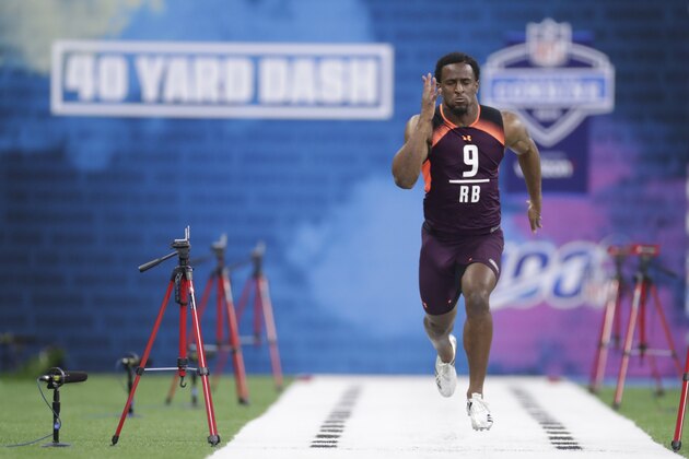 Oklahoma State running back Justice Hill runs the 40-yard dash at the NFL football scouting combine in Indianapolis, Friday, March 1, 2019. (AP Photo/Michael Conroy)