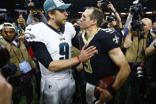 Philadelphia Eagles quarterback Nick Foles (9) and New Orleans Saints quarterback Drew Brees (9) speaks after an NFL divisional playoff football game in New Orleans, Sunday, Jan. 13, 2019. The Saints won 20-14 to advance to the NFC Championship. (AP Photo/Butch Dill)