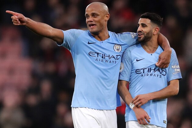BOURNEMOUTH, ENGLAND - MARCH 02: Vincent Kompany of Manchester City celebrates with teammate Riyad Mahrez of Manchester City following the Premier League match between AFC Bournemouth and Manchester City at Vitality Stadium on March 02, 2019 in Bournemouth, United Kingdom. (Photo by Richard Heathcote/Getty Images)