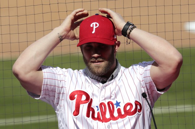 Bryce Harper adjust his cap as he introduced as a Philadelphia Phillies player during a news conference at the team's spring training baseball facility, Saturday, March 2, 2019, in Clearwater, Fla. Harper and the Phillies agreed to a $330 million, 13-year contract, the largest deal in baseball history. (AP Photo/Lynne Sladky)