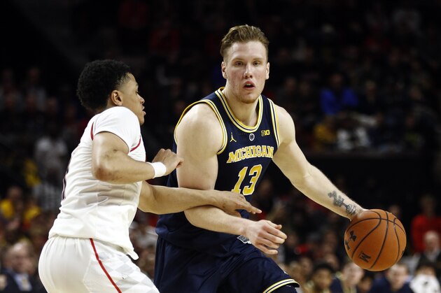 Michigan forward Ignas Brazdeikis, right, of Canada, drives against Maryland guard Anthony Cowan Jr. in the first half of an NCAA college basketball game, Sunday, March 3, 2019, in College Park, Md. (AP Photo/Patrick Semansky)